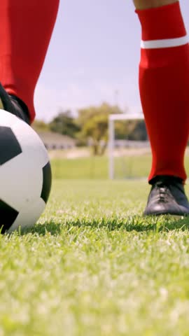 Football player playing with ball on the football ground