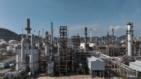 Oil storage tank with oil refinery plant background, Global business power and energy chemical barrel, Oil refinery factory oil storage tank, Petrochemical industrial with blue sky. - Powered by Shutterstock - Get 15% off with code: PIKWIZARD15