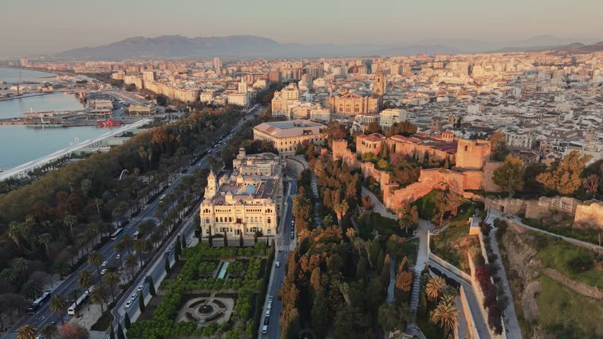 Beautiful aerial panorama of Malaga city at sunrise including the City Hall and historic parks, Spain. Malaga and the Alcazaba fortress. Malaga city center reveals the Cathedral and old town streets