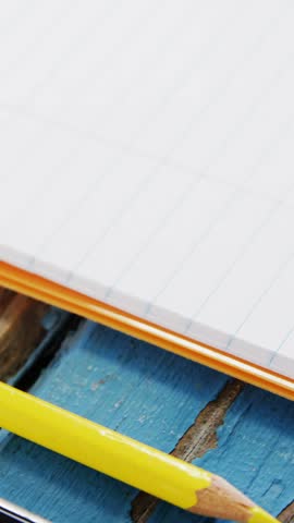 Smartphone, pencil and cup of coffee on wooden surface