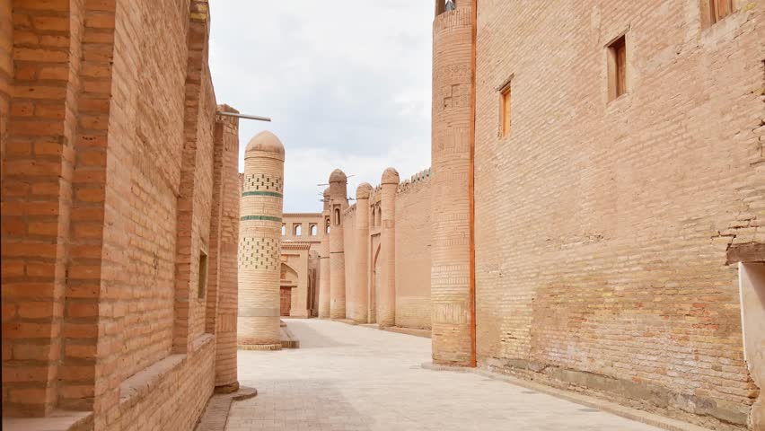 Daytime timelapse of the massive mud-brick fortress walls of Itchan Kala in Khiva. A cinematic look at the ancient Silk Road fortifications and desert architecture of Uzbekistan.