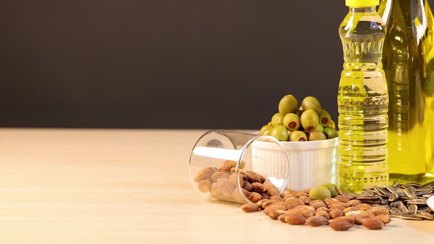 Assortment of healthy fats, oils, nuts, avocado, coconut, butter, bacon.