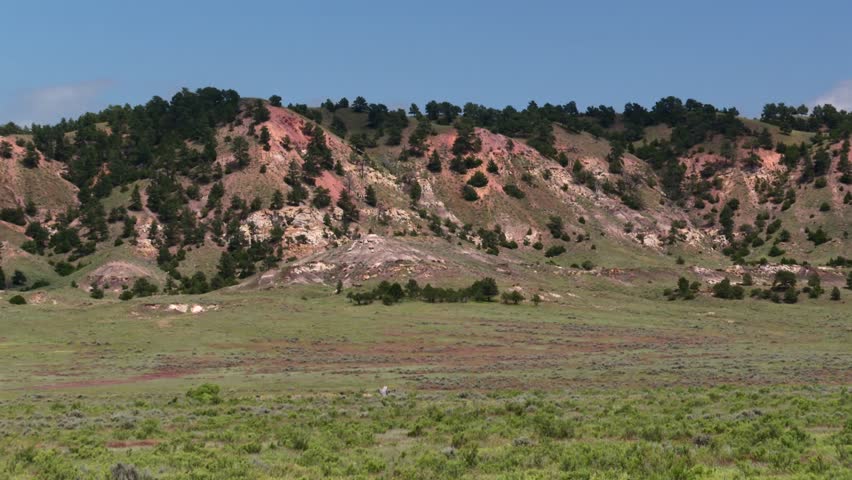 Nebraska, USA badlands showing geological formations and arid plain, static shot
