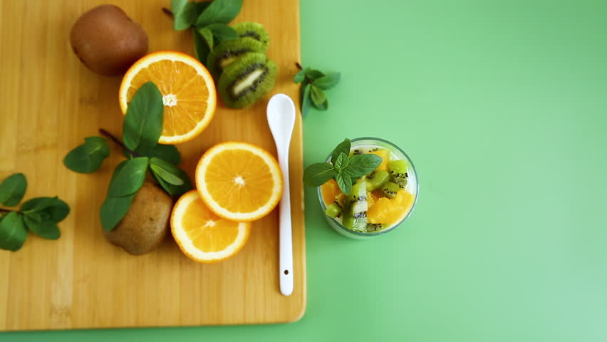 healthy breakfast yogurt with fresh kiwi and orange topping