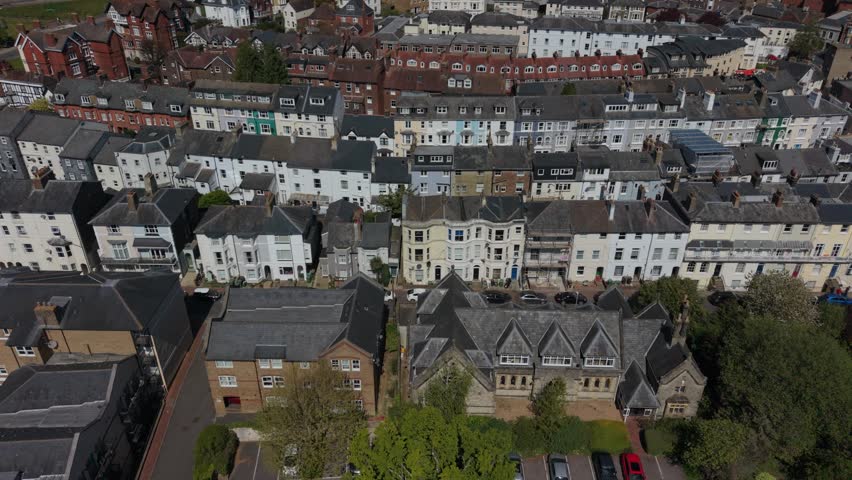Royal Tunbridge Wells streets and houses on the hill. Attached colorful houses in historic town. Typical English housing architecture in Kent. Dense urban area on the hill close to town center on a sunny day.
