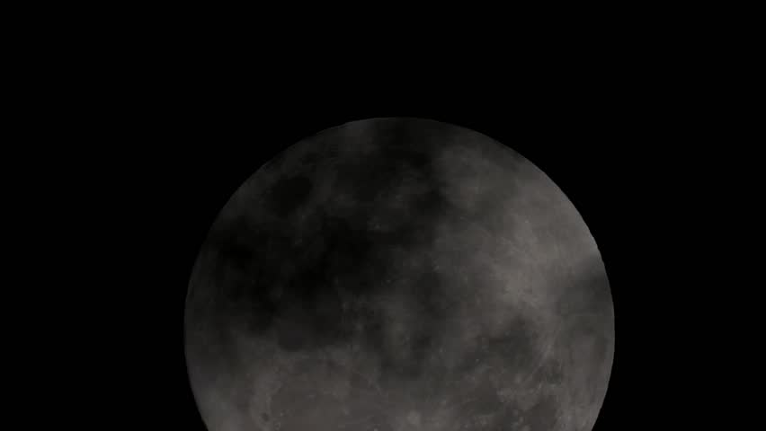 the moon at night is passed by clouds
