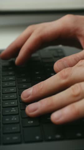 Close up male fingers typing text on black laptop keyboard, freelancer working on new project, writing code, sending email while working remotely in office. Male hands typing on laptop keyboard.