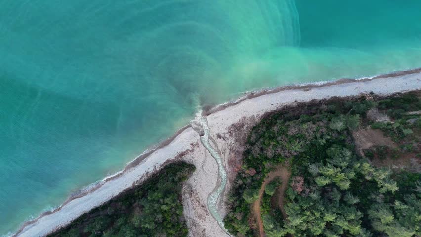 Aerial drone view of a river flowing through forest into the Black Sea at Abana Catalzeytin border in Kastamonu Turkey scenic untouched nature with coastline and calm sea