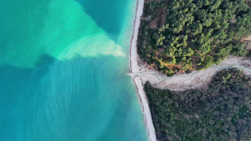 Aerial drone view of a river flowing through forest into the Black Sea at Abana Catalzeytin border in Kastamonu Turkey scenic untouched nature with coastline and calm sea
