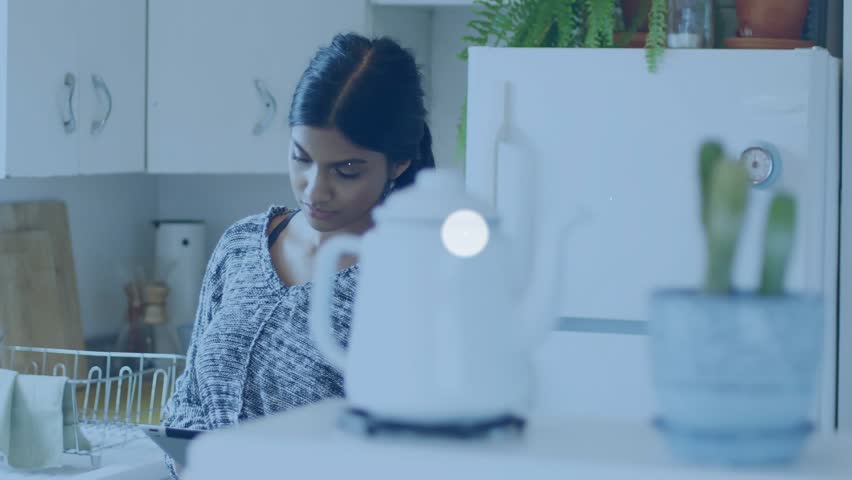 Woman tapping tablet in kitchen, initiating expanding overlaying network graphic for viewing links. Visualization, connectivity, interactivity, focus, home, countertop, modern