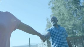 Senior couple on walk, woman extending arm, man reaching, responding, handholding techUI fading. Duo, elderly, outdoor, hillside, path, bluesky, nature - Powered by Shutterstock - Get 15% off with code: PIKWIZARD15