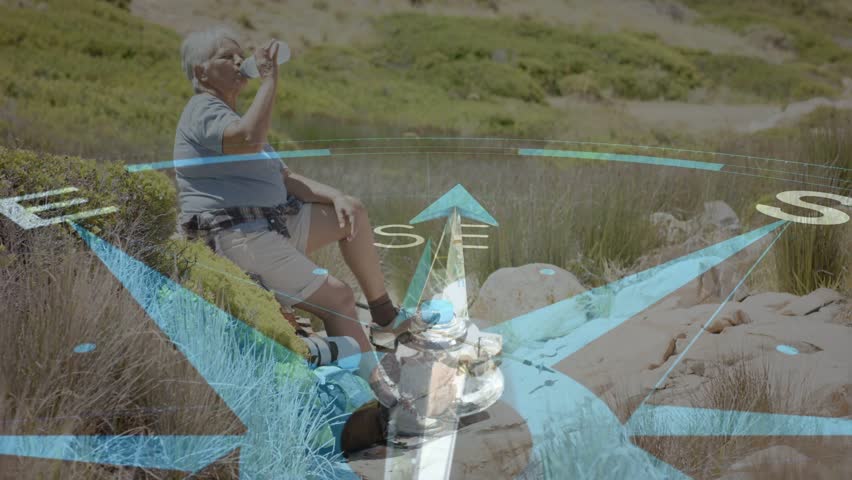 Senior woman resting with bottle handling camera, scanning horizon, causing travel compass overlay. Coastal, rocky, hiking, hydration, gear, navigation, outdoors