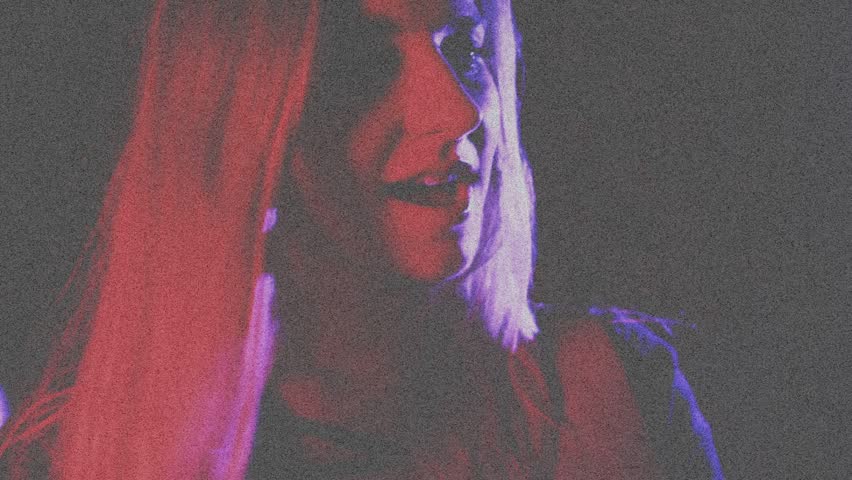 Female singer leaning smiling singing, causing pulsing stars, swirling lights across face for music. Psychedelic, projections, stage, studio, neon, vibrant, abstract