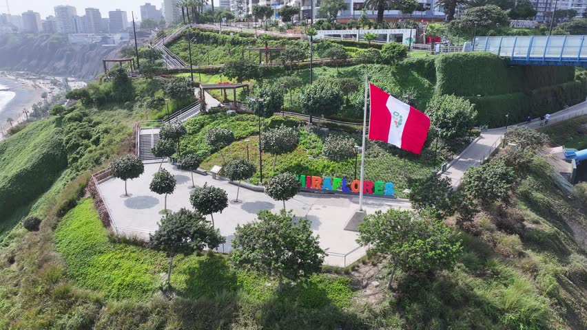 Peru Flag Waving In Miraflores In Lima Peru. Miraflores Sign Scenery. Downtown District. Travel Destination. Peru Flag Waving In Miraflores In Lima Peru. Nature Park.