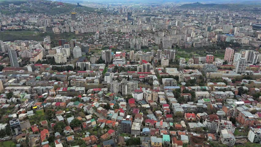 Cityscape with modern buildings and mountains. Tbilisi, Georgia
