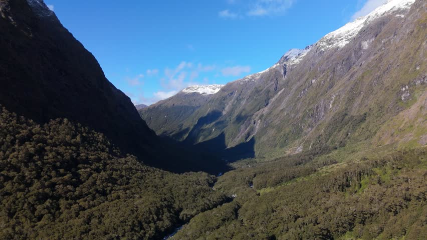 Aerial Fiordland Snow Peak Above Forest NZ 4K