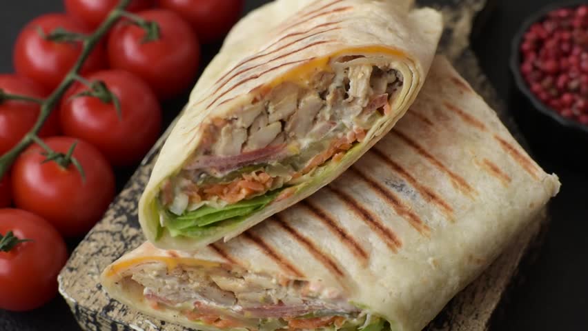 Shawarma with chicken or beef, tortilla roll, and vegetables. Shawarma with meat
