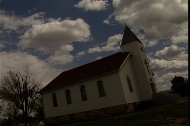  Isolated church shot at tilted angle under low hanging clouds in Russell, Kansas.