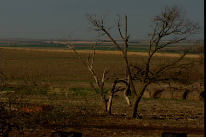Pan over empty and desolate plains to a single abandoned church in Russell, Kansas.