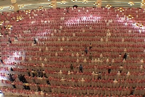 RIYADH, SAUDI ARABIA - OCTOBER 01, 2002: Overhead view of university mosque. Hundreds of men dressed in white, with red and white checked keffiyeh, standing and bowing in unison.