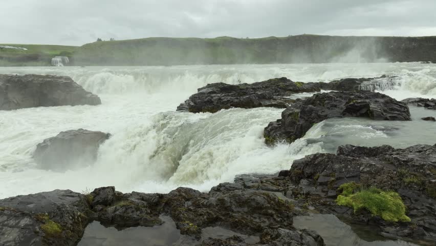 Aerial flight over the beautiful Urriafoss waterfall on a summer day in Iceland.