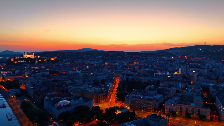 Dusk time of the old town in Bratislava, Slovakia. Well-lit Bratislava Castle on the hill. Aerial view.