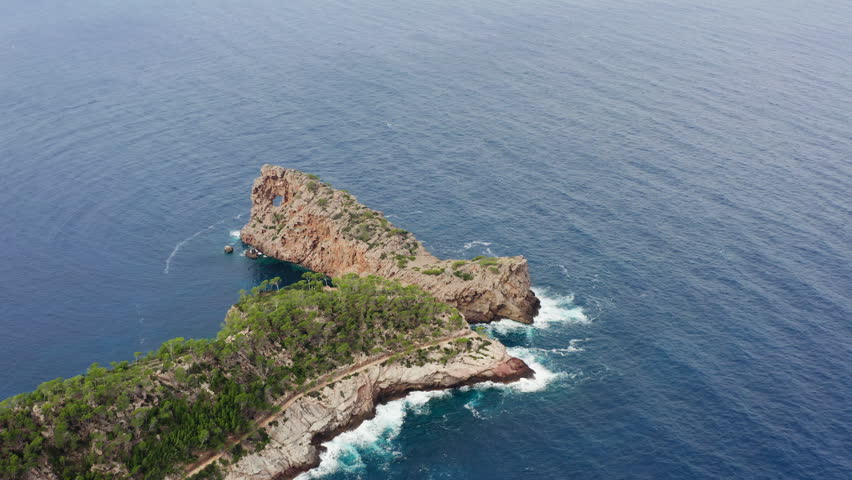 Drone view of Mallorca coastline with waves hitting rocky shore beautiful Mediterranean landscape island scenery and travel destination in Spain Europe