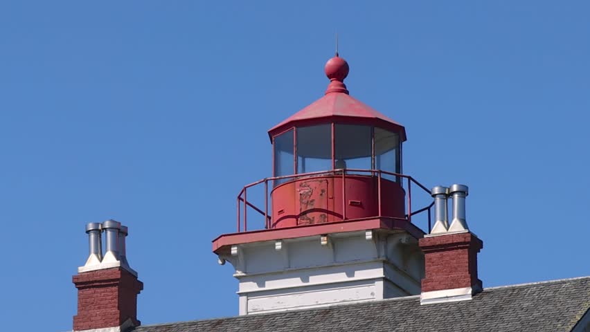 Historic wooden Yaquina Bay Lighthouse in Newport, Oregon, a popular landmark on the Pacific coast.