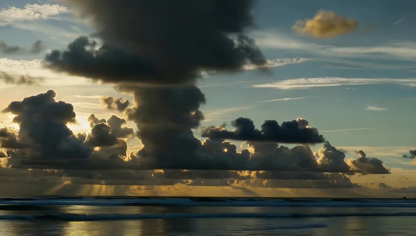 Dramatic Sunset with Sunbeams Over Ocean Beach