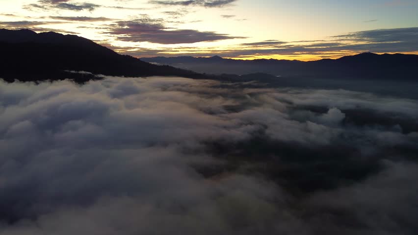 Aerial View of Misty Mountain Valley at Sunrise