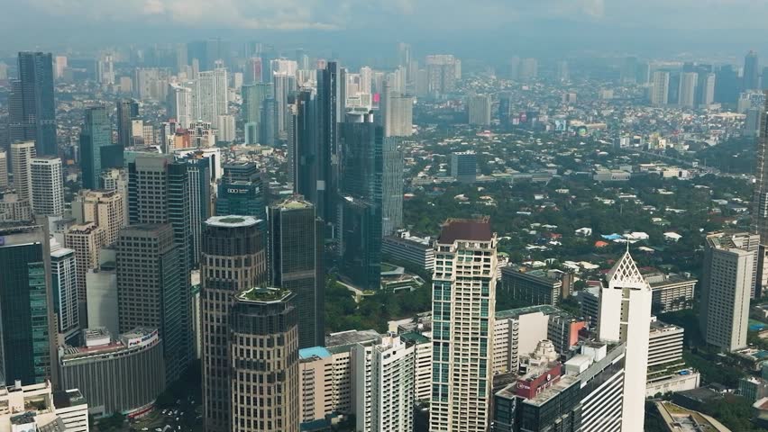 Aerial view of high rise buildings and residential towers in Makati City. Metro Manila, Philippines.