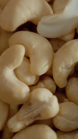 Vertical Screen: Cashew pieces are shown in a rustic bowl, highlighting their texture and color. Ideal for snacking or adding to various dishes, these nuts are nutritious and versatile.