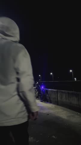 Man Walking Bicycle at Night