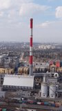 Vertical screen Close Aerial Warszawa Single Stack Chimney, Detailed Plant Rooflines With Rail Wagons, Cargo Containers, Conveyor Systems, Cloudy Sky And Industrial Logistics Activity - Powered by Shutterstock - Get 15% off with code: PIKWIZARD15