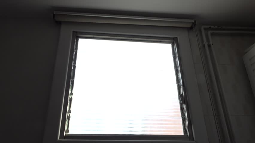 person raising and lowering a window shade. High quality 4k footage