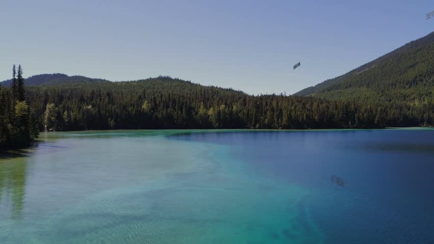 Geometric network appearing above turquoise lake, growing into spherical globe visualizing data. Mountains, conifer, water, forest, panorama, tranquil, outdoors