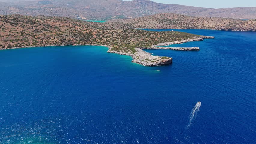Flying over the turquoise waters and rocky coastline of Kolokitha peninsula, Crete