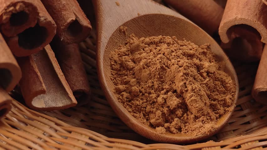 Cinnamon powder on a wood bowl