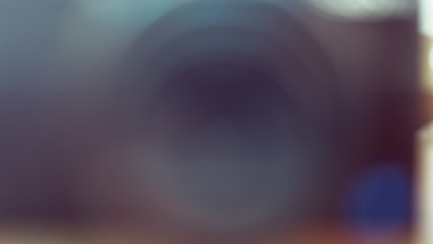Close up macro shot of a camcorder lens focusing and adjusting aperture creating depth of field.