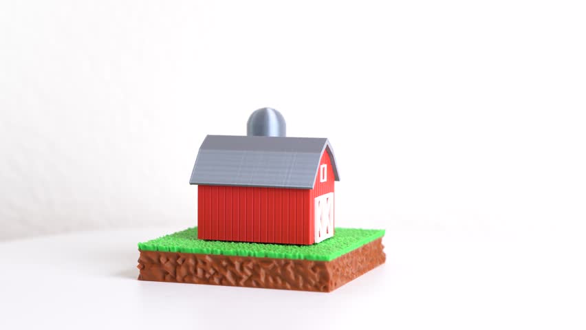 A farm barn with a silo on a plot of green grass. Agribusiness and farming operations. Agricultural production supports food supply chains and rural economy development through land management.