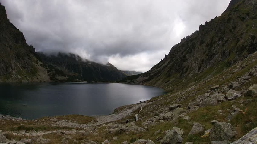 Scenic view of a mountain lake surrounded by rugged peaks.
