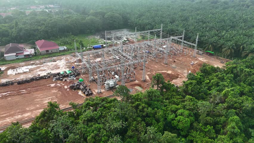 Aerial View of the Construction of a Electrical Substation and Transformers Near Oil Palm Plantation Infrastructure.