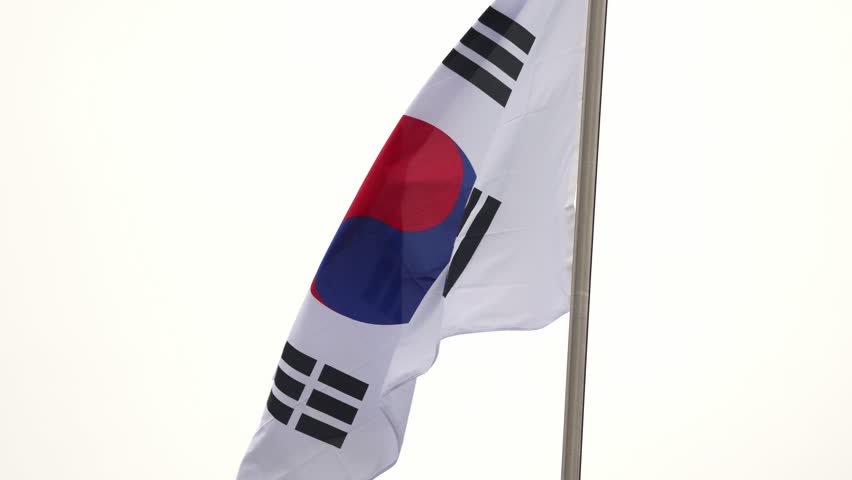 South Korean flag known as Taegeukgi waving against a bright white background