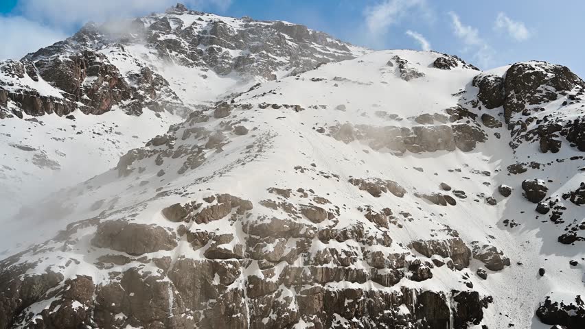 Rugged peaks of Mount Toubkal in the Atlas Mountains of Morocco under a clear blue sky