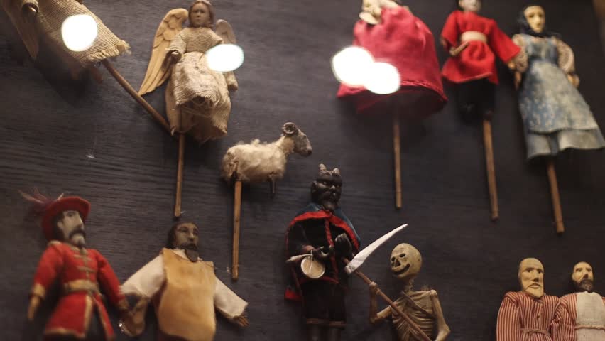 A collection of dolls and figurines on a wall, great for decorating or storytelling.