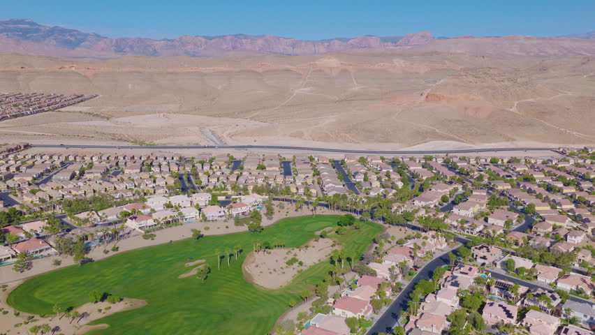 Southwest Las Vegas Aerial Pullback View of Golf Course Homes Below Desert Hills