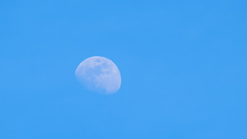 Clear view of moon at blue sky. 