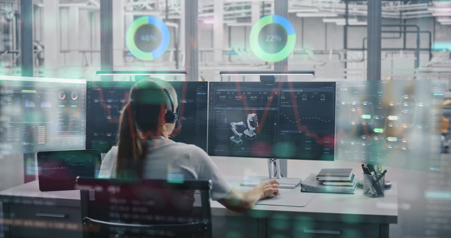 Young Female Engineer in Headset Sits at Desk, Monitoring Automated Robotic Arms Through Multiple Screens With Glowing VFX Charts, Holograms, and Production Data Analytics. Concept of Industry 4.0.