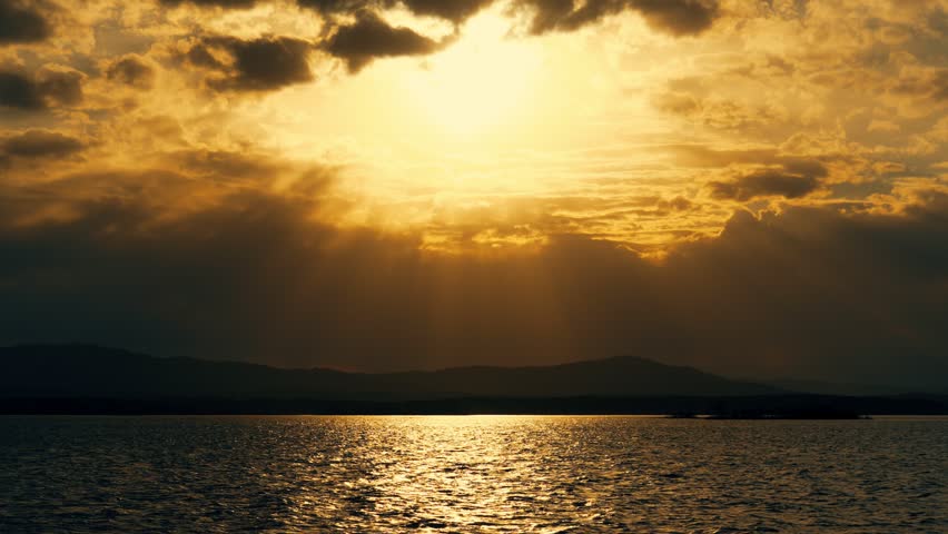 Twilight golden sunset with a landscape view of the lake. Extraordinary natural beauty.	