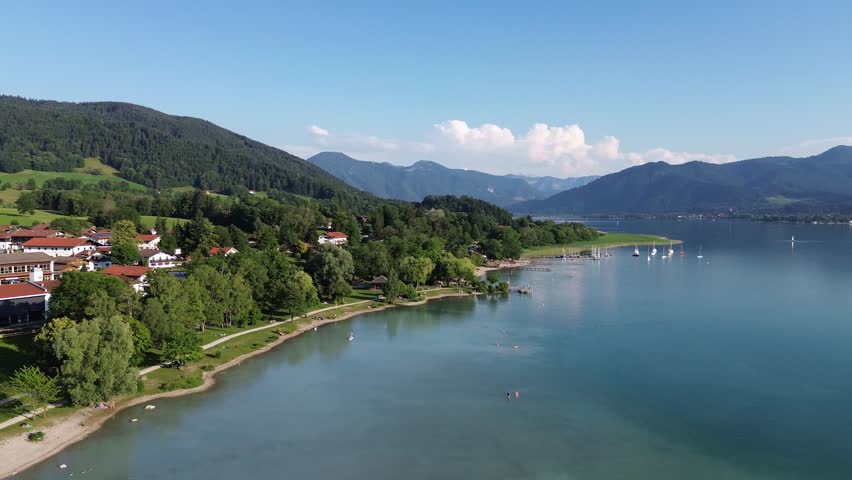 Aerial Panorama of Coastal City with Residential Houses and Green Parks Along the Blue Sea Shore Under Clear Sky